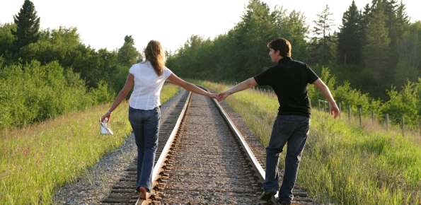 Holistic Counseling - Couple Walking on Train Tracks